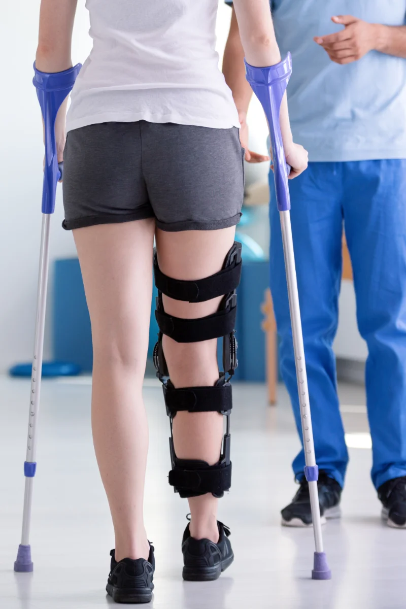 Térd ínáthelyezés utáni felépülés térdrögzítővel és járókeretes támogatással